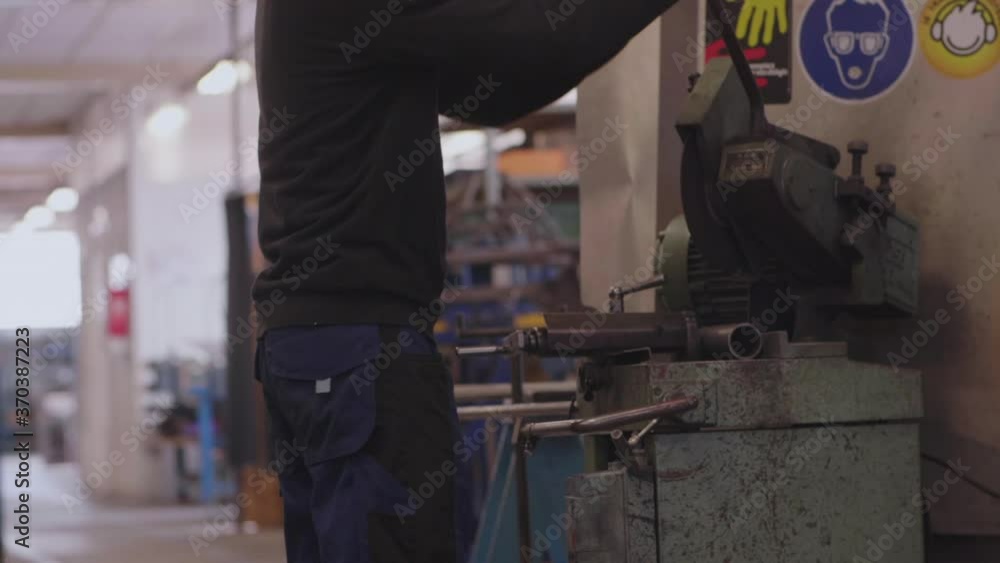 Man operating a metal grinder, slowmotion Man operating a metal grinder, slowmotion