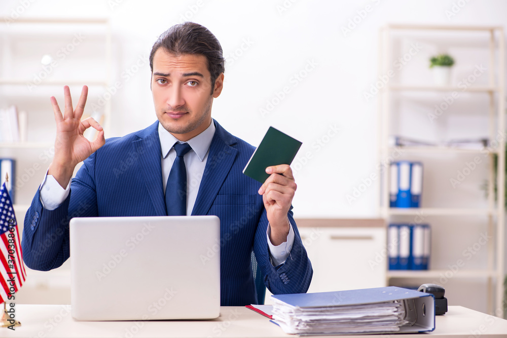 Young man checking passport at USA embassy Young man checking passport at USA embassy