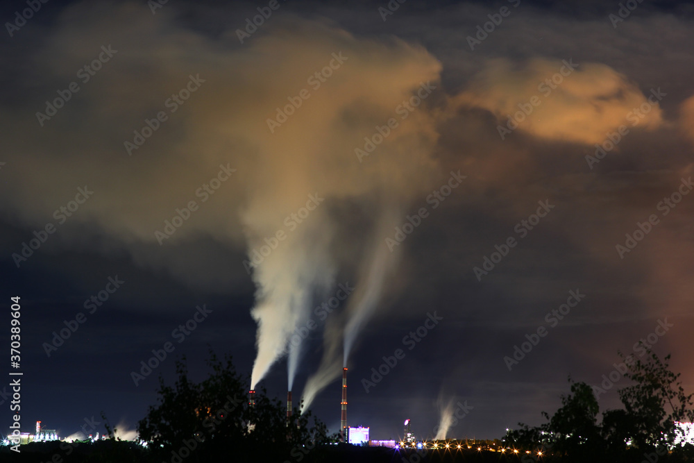 an environmental problem with a view of Smoking factory chimneys in the night sky an environmental problem with a view of Smoking factory chimneys in the night sky