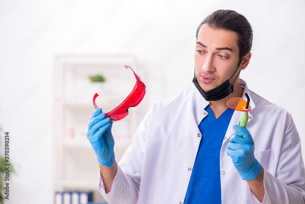 Young male dentist working in the clinic Young male dentist working in the clinic