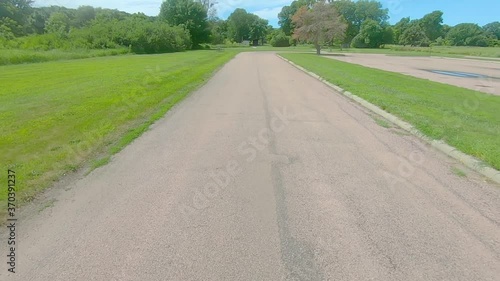 POV thru the rear window while driving thru a rural county park and past prairie and alfalfa field in rural South Dakota photo