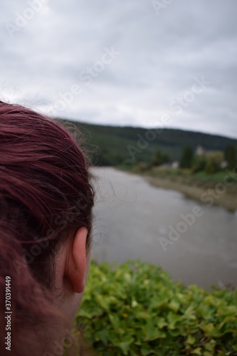 Girl Looking out across a blurry River