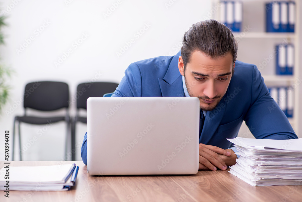 Young male businessman working in the office Young male businessman working in the office