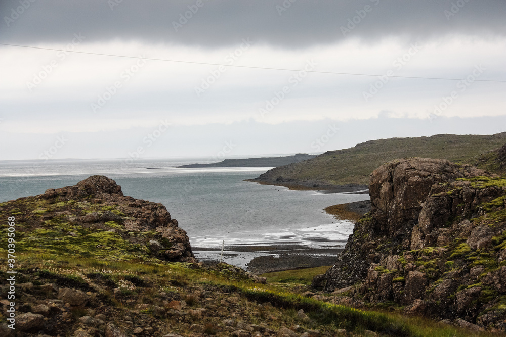 Rocky coast and Atlantic ocean in cloudy weather, nature of Iceland