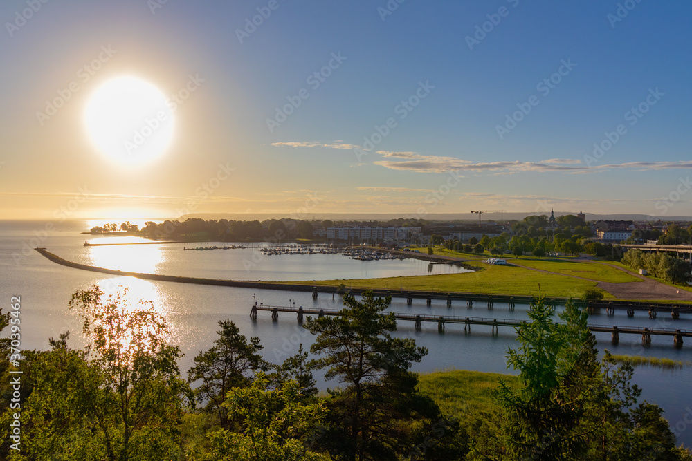Landscape photograph of the inlet and piers of the city of Vänersborg, Sweden, taken at sunrise in an early morning.