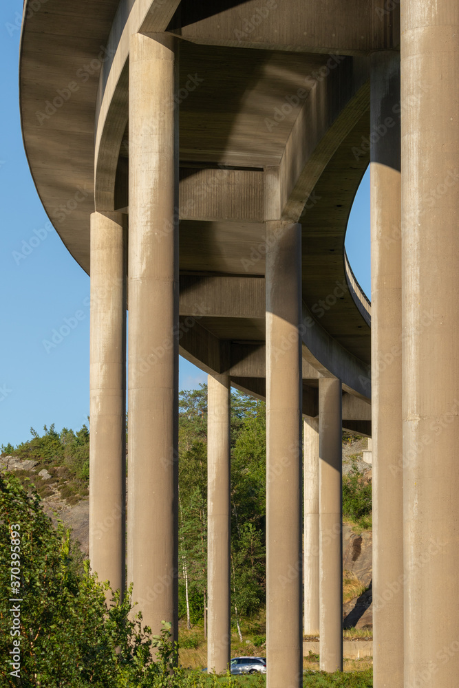 View from under a concrete bridge. Water is reflecting from the sea