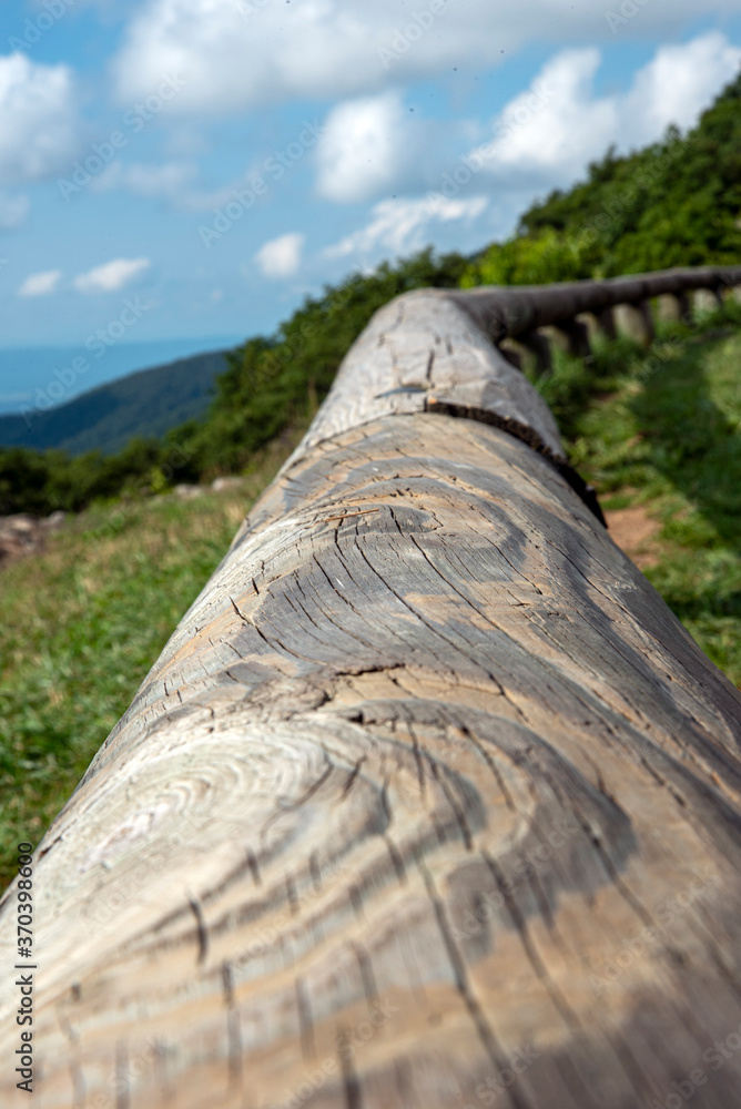 Fototapeta premium wooden fence along with the hill road