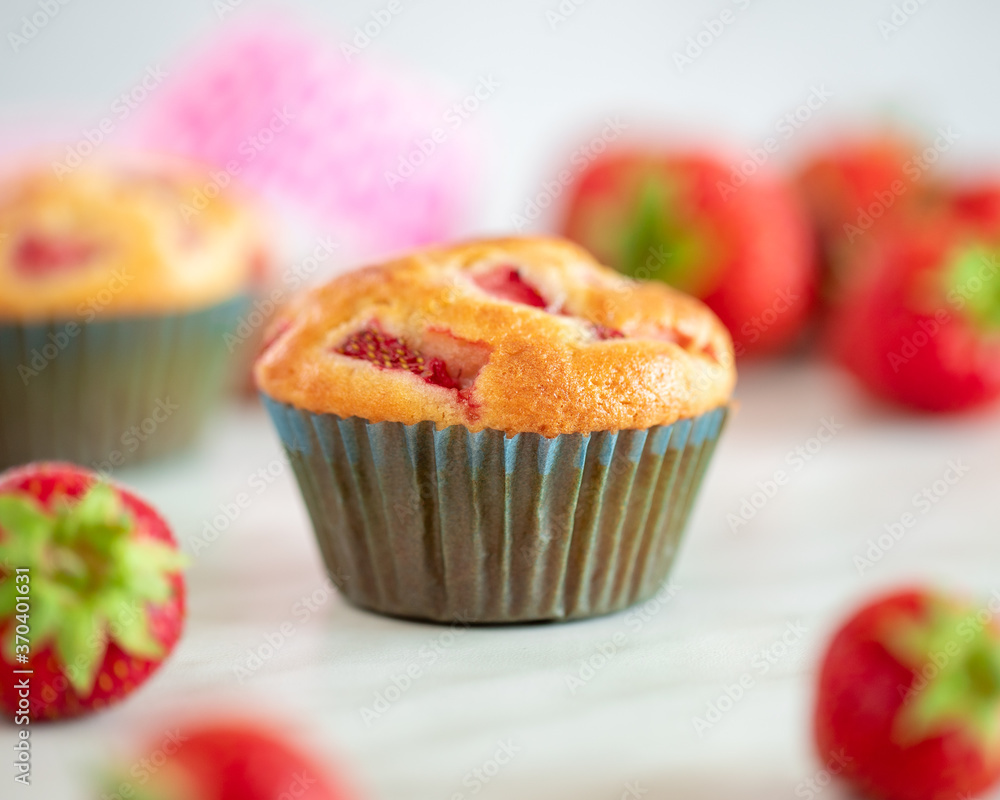 Cupcakes with strawberries on a marble background