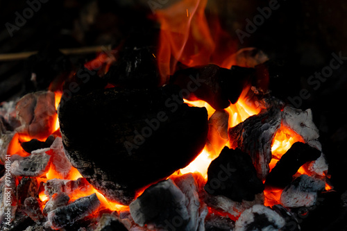 detail of fire and charcoals inside a firing barbeque