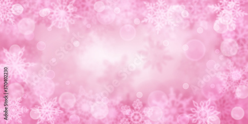 Christmas background of blurry snowflakes in pink colors