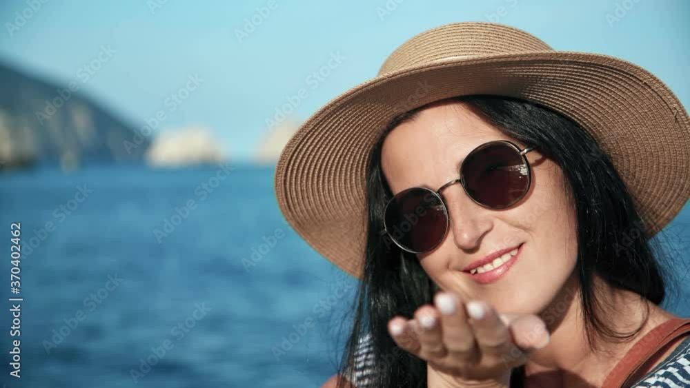 Closeup face of touristic female blow air kiss and smiling. Shot on RED Raven 4k Cinema Camera Closeup face of touristic female blow air kiss and smiling. Shot on RED Raven 4k Cinema Camera