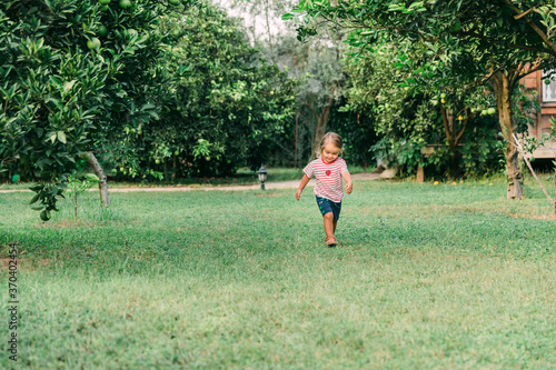 Toddler girl running in garden