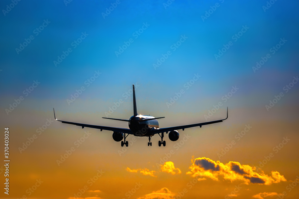 Plane flying tail and landing on a sunset. High quality photo