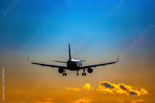 Plane flying tail and landing on a sunset. High quality photo