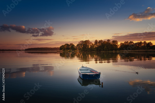 Fototapeta Naklejka Na Ścianę i Meble -  Rowing boat floating over the Elckie Lake waters. Masuria, Poland.