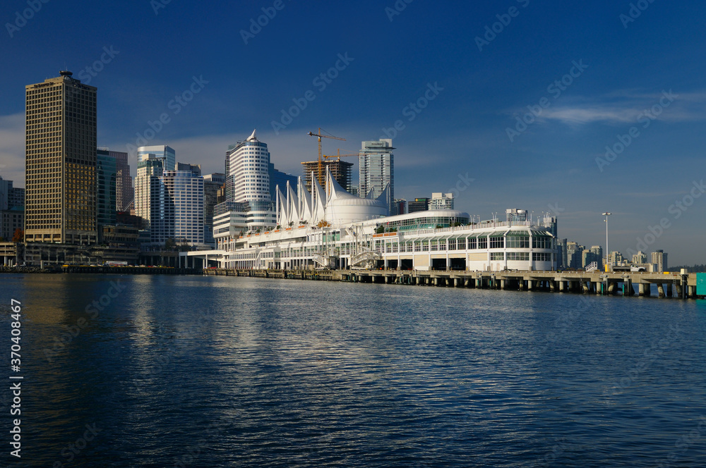Canada Place sails floating on pilons and Vancouver waterfront with downtown high rise towers