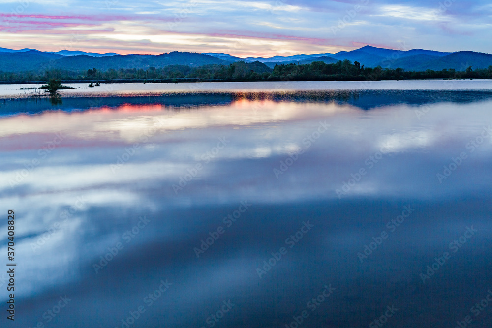 Fototapeta premium mountains of the Blue Ridge reflect in Lake Wilson after heavy rain