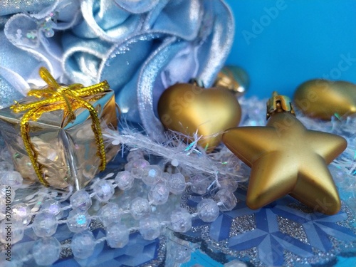 Beautiful blue background for a christmas card with gilged gold toys on the christmas tree photo