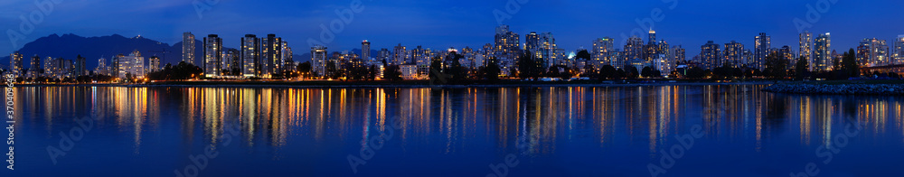 Wide Panorama of West End Vancouver skyline at twilight reflected in English Bay