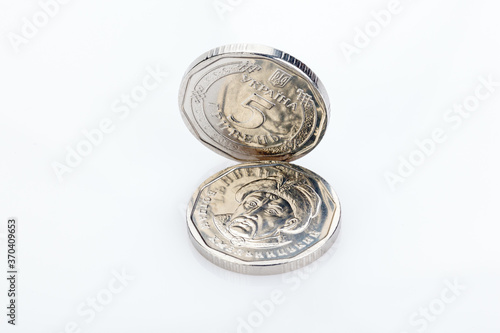 Ukrainian money. Five grivna hryvnia new coins isolated on white. Money of Ukraine. Ukrainian national currency. close-up photo