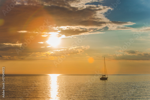 view of sail boat on sunset in bay. summer vacation © phpetrunina14