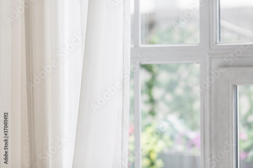 Window with a transparent curtain. Close-up.