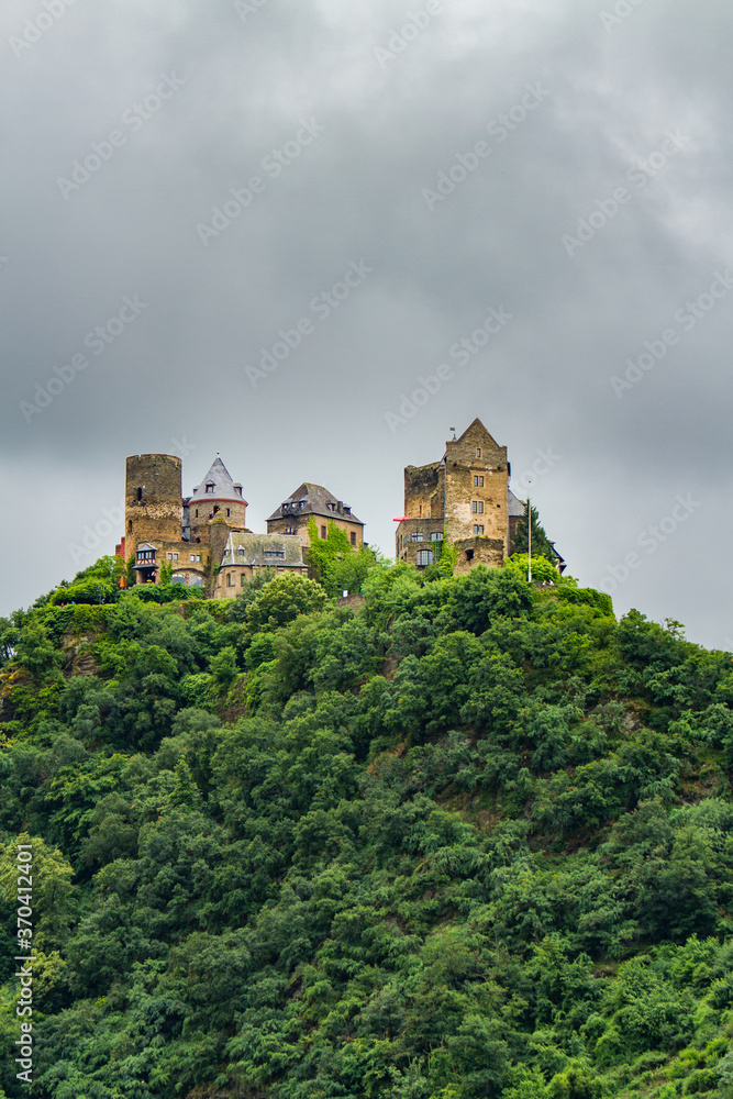 The Schonburg Castle is on a hill above the Rhine River and the village of Oberwesel The Schonburg Castle is on a hill above the Rhine River and the village of Oberwesel
