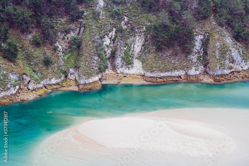 Beautiful water in Pechón, el último pueblo de Cantabria. Las cuevas de la playa de Pechón, son un entorno cántabro perfecto para relajarse y disfrutar de la naturaleza. photo