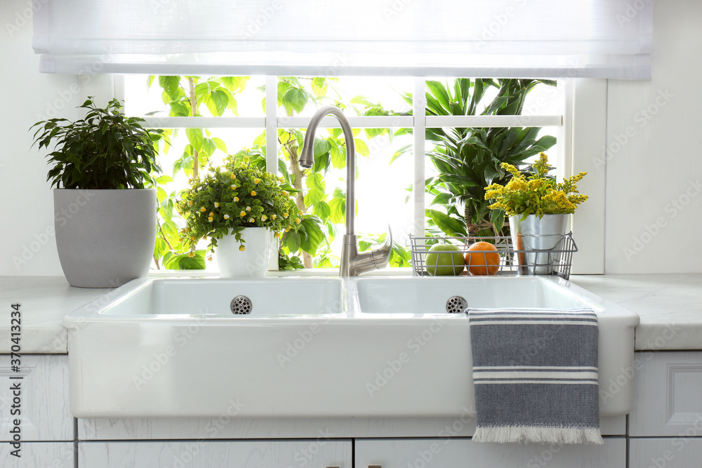 Beautiful white sink near window in modern kitchen Stock Photo | Adobe ...