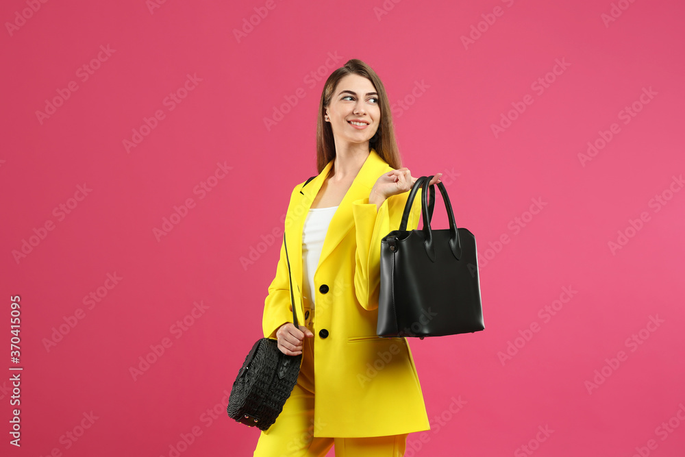 Beautiful young woman with stylish bags on pink background Beautiful young woman with stylish bags on pink background