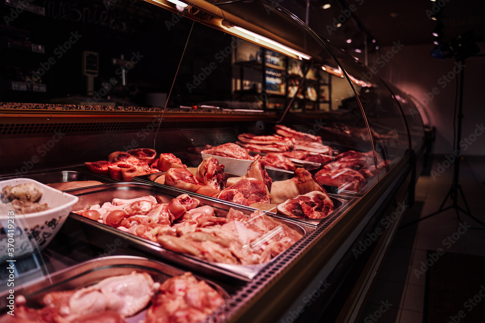 Butcher shop's meat counter. Meat business. Cold and quality meat sale. Raw of counters.