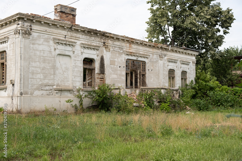 Old house with a unique design in baroque style in Romania abandoned and allowed to grow grass 