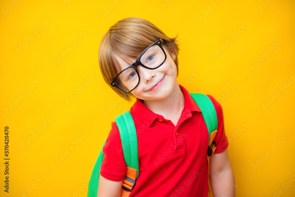 Back to school. Little boy in glasses with bag. Success and happy kid isolated on yellow. Coronavirus pandemic, covid-19 education concept