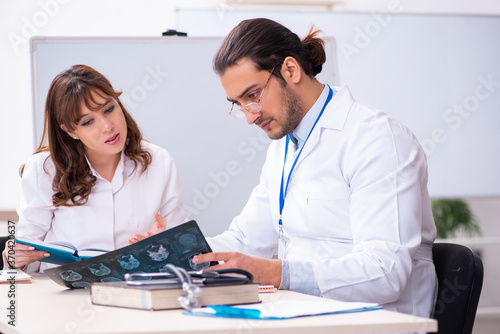 Young male doctor radiologist and female student in the classroo