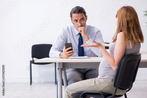 Pregnant woman visiting male psychologist doctor
