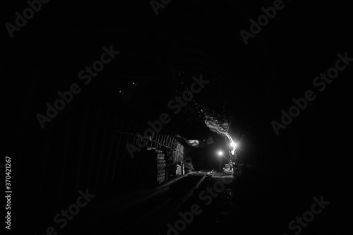 Silhouette of a working miner in a mine