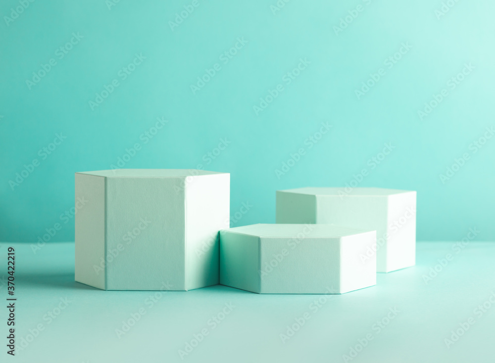 Composition of different geometric objects on pastel mint backdrop. Abstract background with hexagon shape podiums Composition of different geometric objects on pastel mint backdrop. Abstract background with hexagon shape podiums