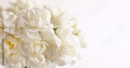 Floral composition made of beautiful white flowers on light backdrop. Floristic decoration. Natural floral background with carnations.