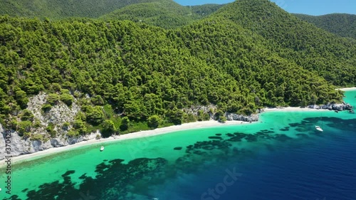 Aerial drone panoramic video of famous turquoise paradise beach of Hovolo covered with pine trees, Skopelos island, Sporades, Greece photo