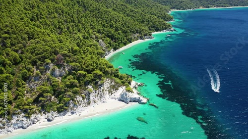 Aerial drone panoramic video of famous turquoise paradise beach of Hovolo covered with pine trees, Skopelos island, Sporades, Greece photo