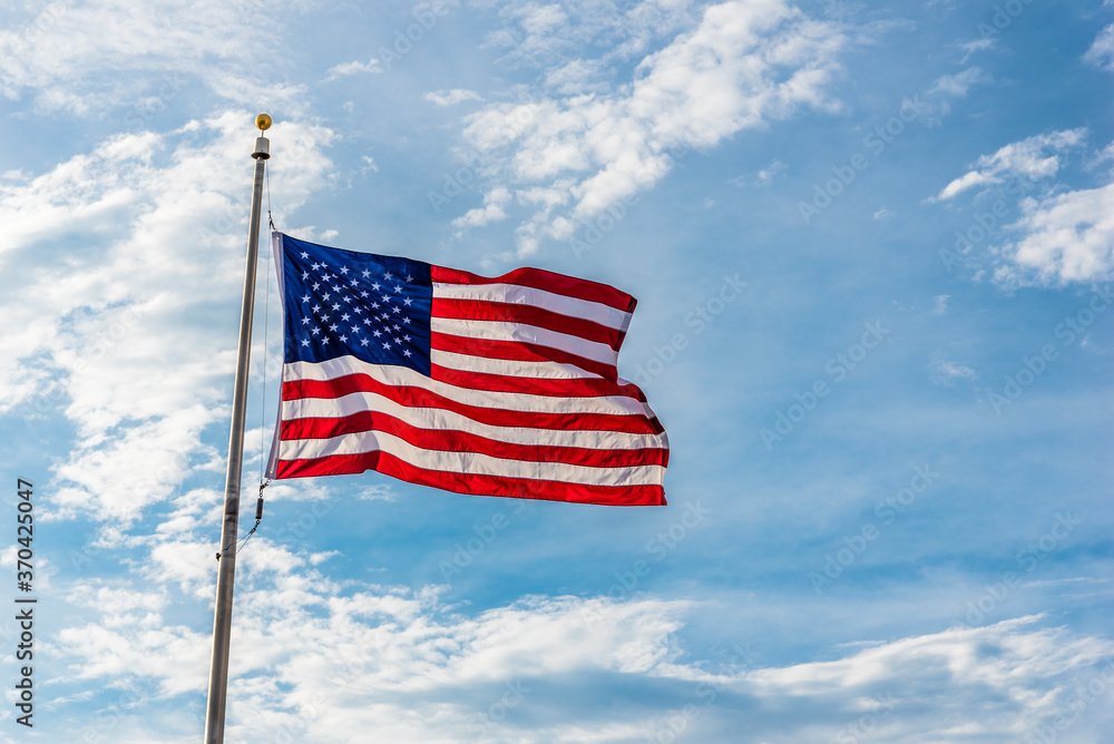 The American flag against a blue sky. The American flag against a blue sky.