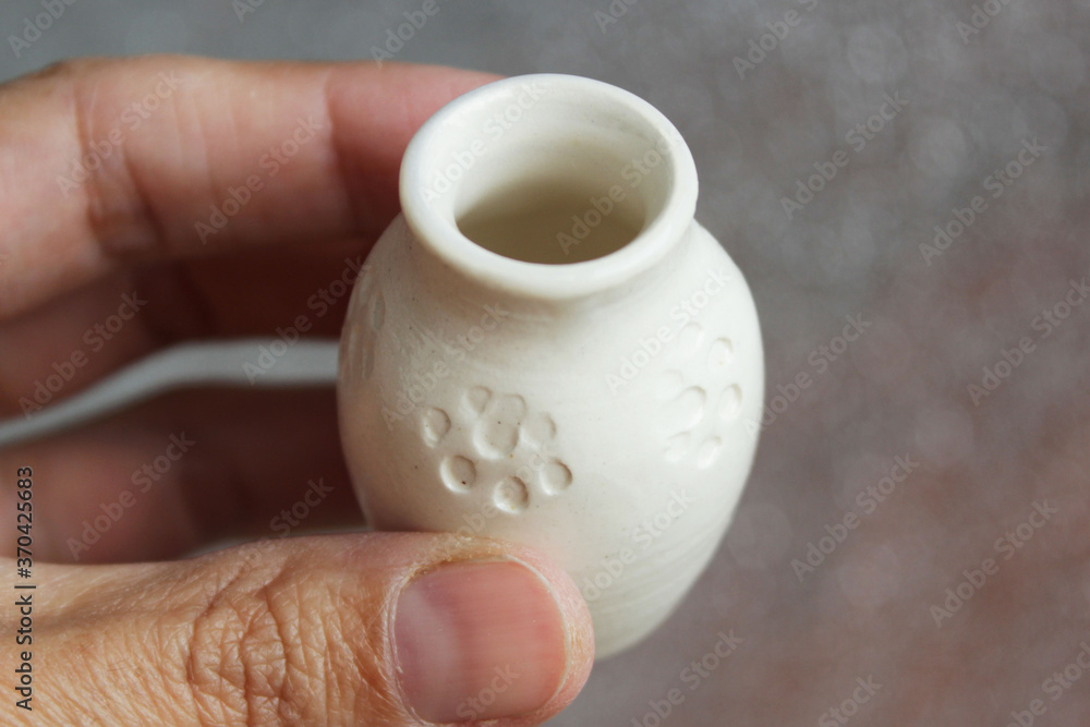 small handmade white clay with cat paws pot for making wishes or flowers from boutonnieres. Decor transparent glaze, two firing