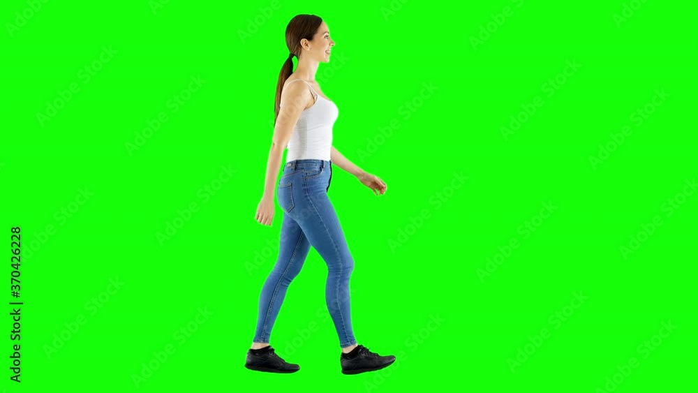 Young Smiling Brunette Walking on Green Screen Young Smiling Brunette Walking on Green Screen