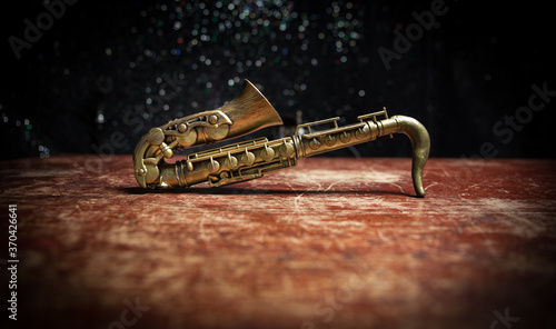 Fotografie Alto gold sax miniature with colorful toned light on foggy background