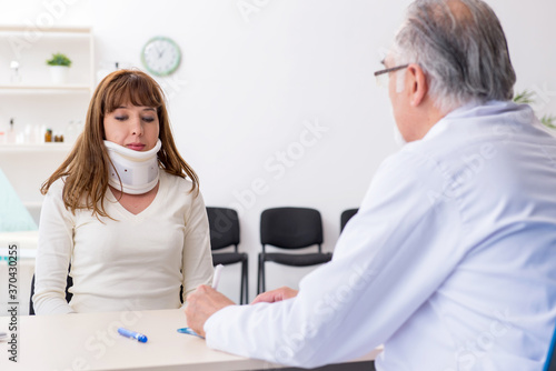 Young injured woman visiting experienced doctor traumatologist
