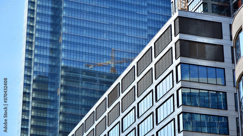 Bottom view of glass silhouette of skyscraper. Business building. Skyscraper with glass facade. Modern building in business district. Concepts of economics, financial, future. Bottom view of glass silhouette of skyscraper. Business building. Skyscraper with glass facade. Modern building in business district. Concepts of economics, financial, future.
