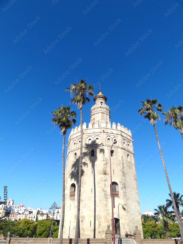 A view of the Guadalquivir River and the Golden Tower, Torre del Oro, in Seville, Sevilla, Andalusia, Spain.