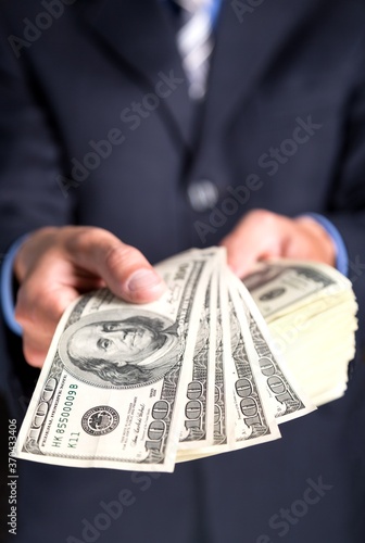 Closeup of a Businessman Showing Dollar Bills