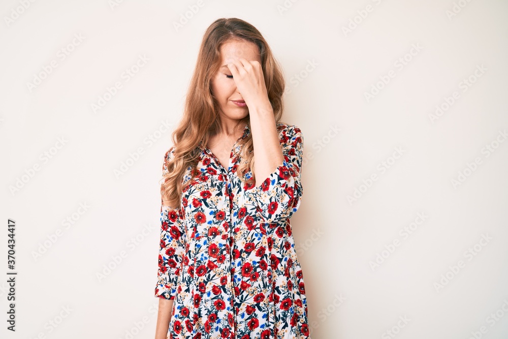 Young caucasian woman with blond hair wearing summer dress tired rubbing nose and eyes feeling fatigue and headache. stress and frustration concept. Young caucasian woman with blond hair wearing summer dress tired rubbing nose and eyes feeling fatigue and headache. stress and frustration concept.