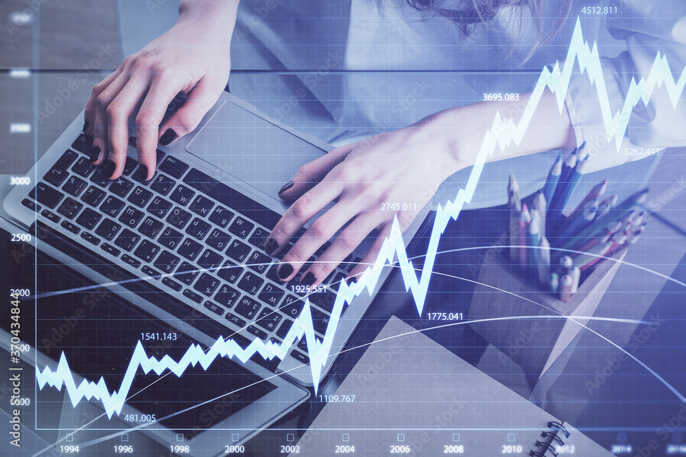 Double exposure of woman hands typing on computer and forex chart hologram drawing. Stock market invest concept. Double exposure of woman hands typing on computer and forex chart hologram drawing. Stock market invest concept.